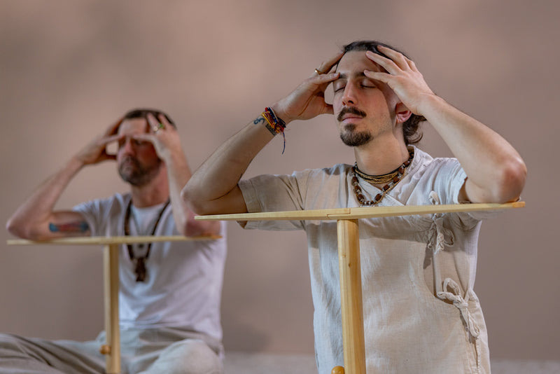 Practitioner using Nada Kriya stick during seated meditation - Bhakti Shop
