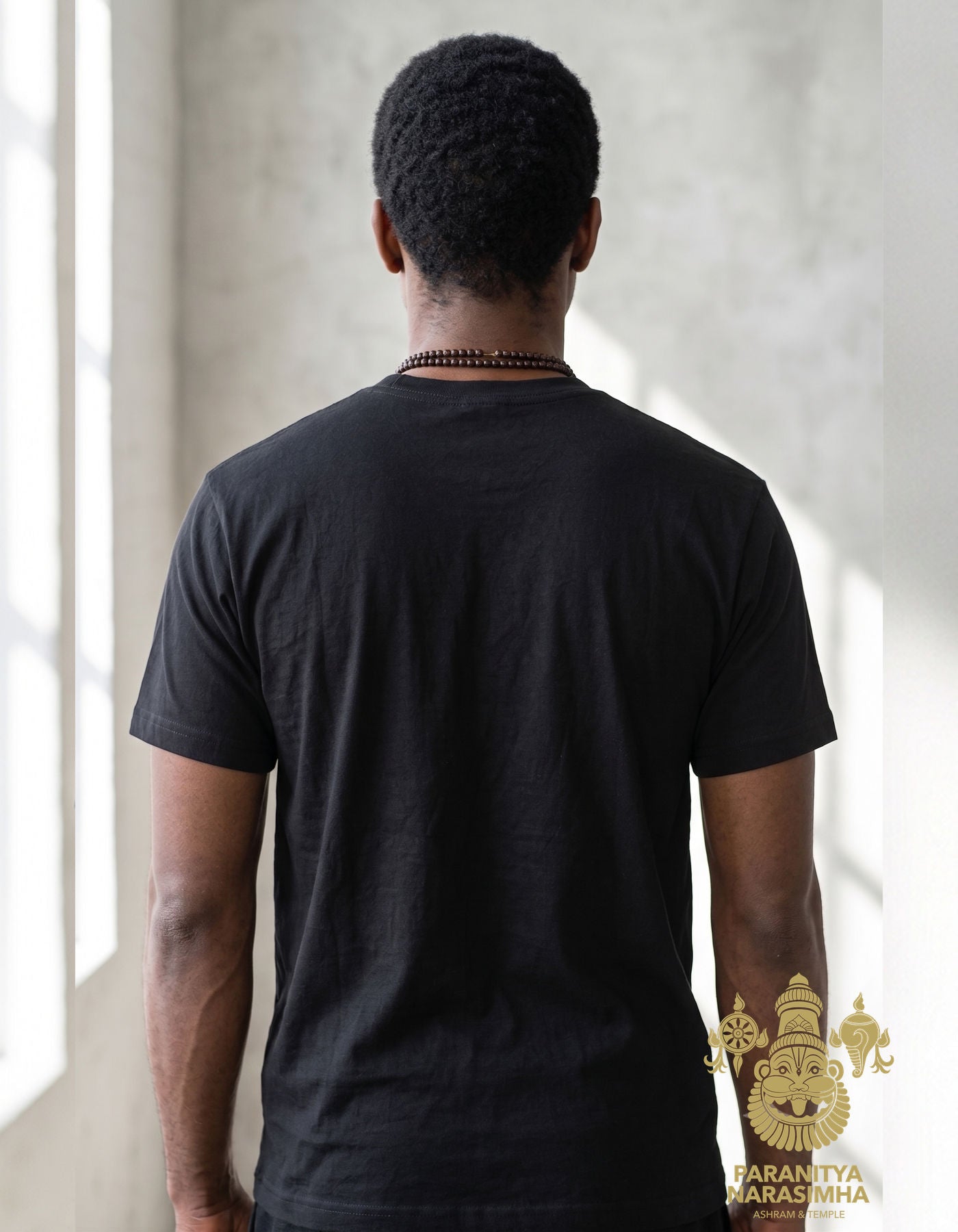 Man wearing black Paranitya Narasimha t-shirt in classic fit - Bhakti Shop